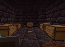 This is a screenshot from someone's (unclear who) stream in minecraft. It's the final control room. Black stone bricks make up the walls and floor and there are five chests evenly spaced around the room with signs to label which chest belongs to who. A single oak button sits in the middle of the room. There are soul lanterns barely in the screenshot but are mostly cropped out. Whoever's perspective this is shows them holding a shield in their off-hand and a dirt block in their dominant hand.